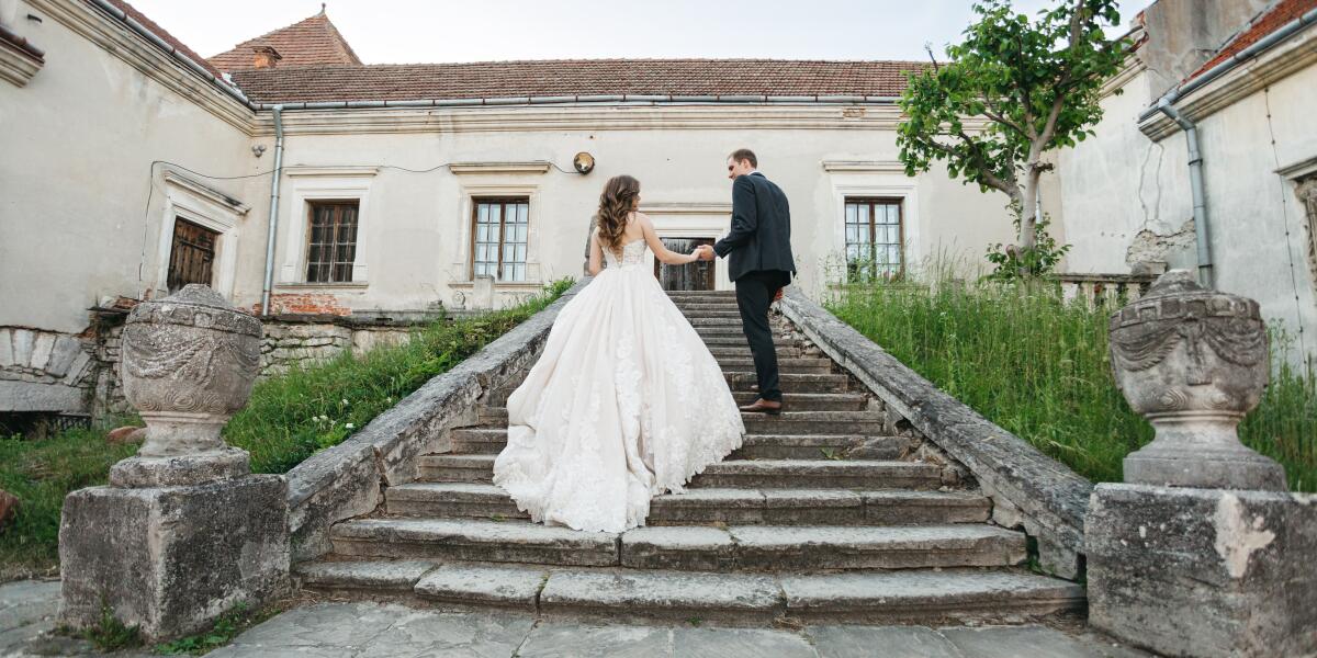 Bride and groom walking up stairs