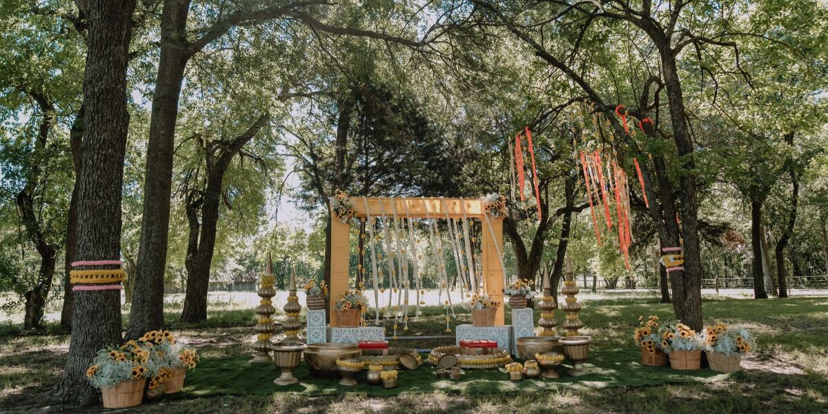 Grove-Pre wedding event setup in the shade of tress to beat summer heat